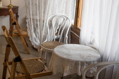 Doğal ışık ve beyaz perdeli beyaz bir masa.