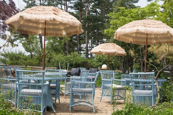 summer straw umbrellas and chiars for the cafes