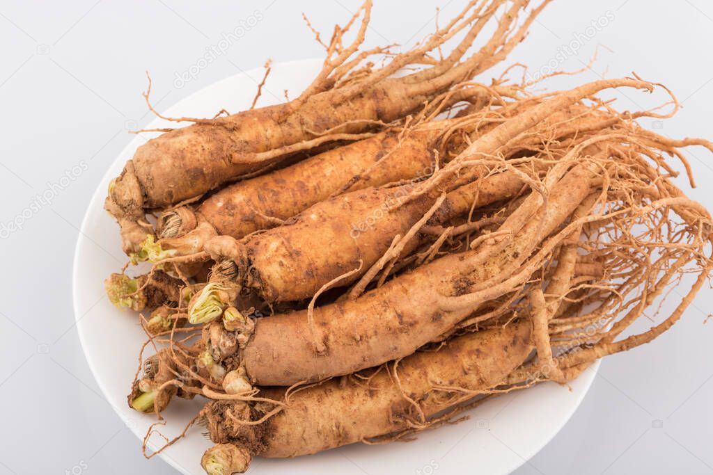 Fresh ginseng roots isolated on white background