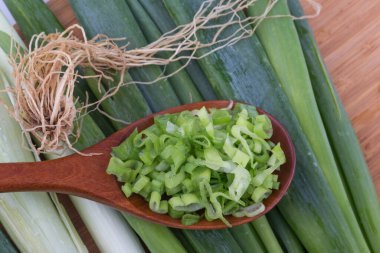 Beyaz arka planda doğranmış taze soğan görüntüsünü kapat
