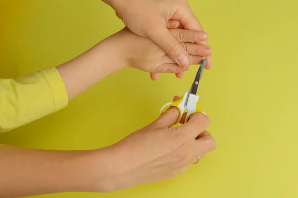 woman cuts baby\'s nails. hands close up