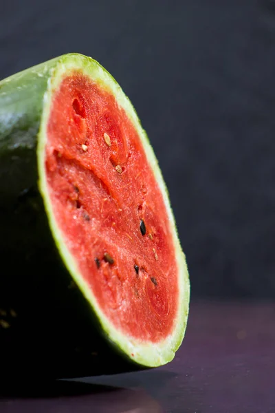 Red seedless watermelon with black background