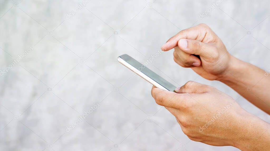 man using a smartphone on gray background.