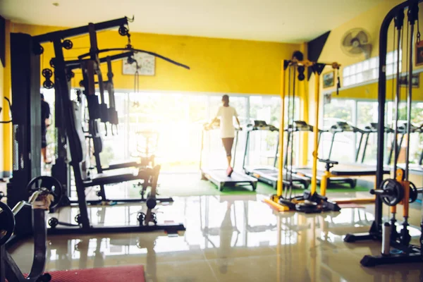 Blur the gym with exercise equipment and light in the morning.