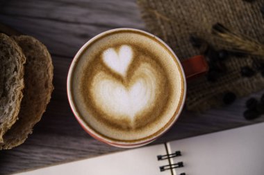 Kırmızı kahve cam ahşap zemin üzerinde duruyor. kavram natürmort