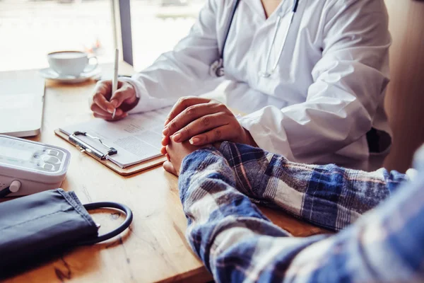 The doctor is discussing with the patient after a physical examination of the results and treatment guidelines.