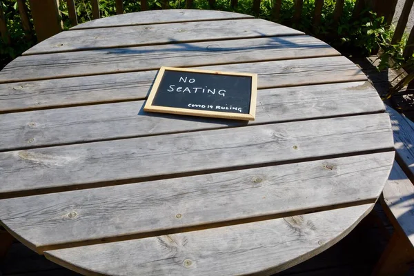 Social distancing markers are on outside tables and chairs to ensure safety after lockdown. No seating signs and one way systems are evident everywhere