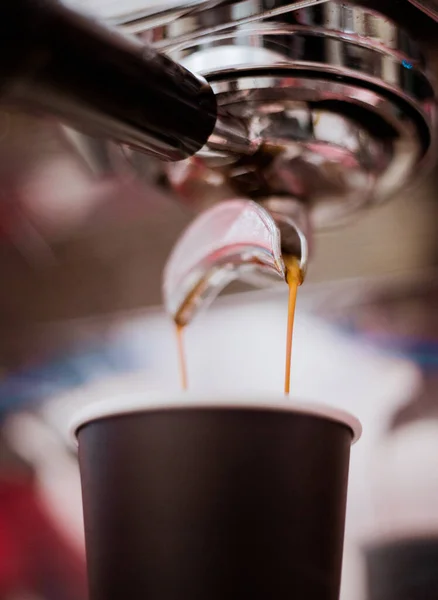 Close-up of espresso pouring from coffee machine. Professional coffee brewing.Soft focus