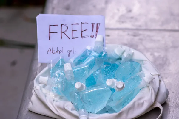 A large amount of blue gel alcohol Is packed in a small bag. Placed in a white cloth bag on the table. For free alcohol gel. for washing hands Anti-virus and anti-bacteria and Covid-19. copy space. Selective focus.