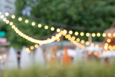 Siracha, Tayland 'daki sahil restoranının ışıklarını bulanıklaştır. Bokeh 'le kafenin arka planı bulanık. Parlak deniz manzarası. Kahve dükkanının soyut bulanıklığı. Turuncu, kırmızı, açık.