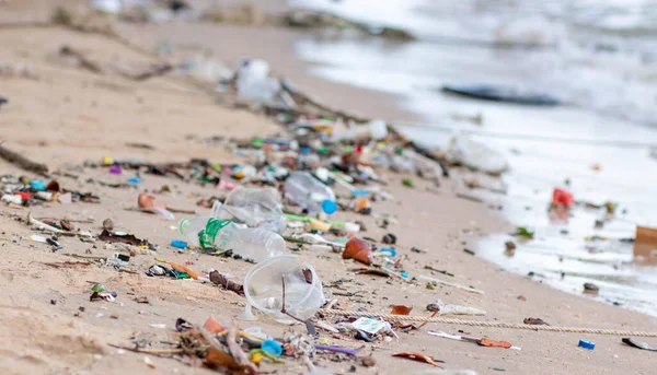 Trash on the Beach. Beach pollution. Plastic bottles and other trash on sea beach. Dirty sea sandy shore the Black Sea.