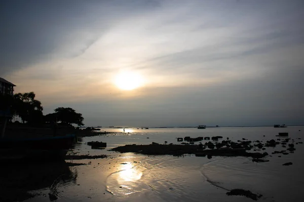 Warm light sunset beach sand boat mirror water ocean sea thailand asia sky orange cloud.