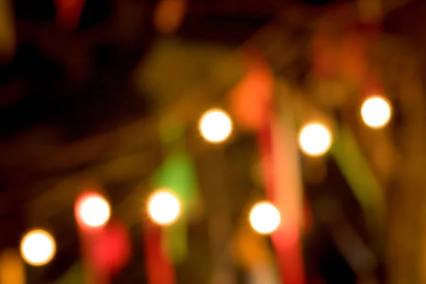 Blur the lights on the restaurant. Blurred cafe background with bokeh. orange ,red, light, blue, green, pink.