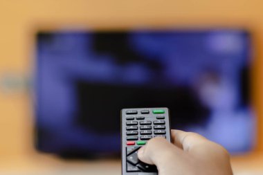 Uzaktan kumandalı televizyonla elinizi kapatın ve düğmeye basın. Televizyon uzaktan kumandası, mavi TV ekranında kanal başparmağını değiştirir.