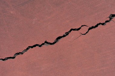 Bir tenis kortunun kırmızı boyalı asfaltının arka planı