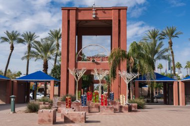 Chandler, Arizona - Dec. 3, 2019: Dr. A. J. Chandler Park decorated for Christmas with gift boxes and white trees in historic downtown. clipart