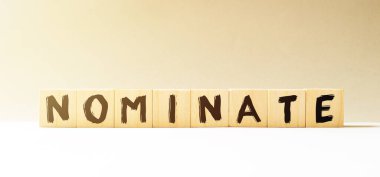 NOMINATE sözcüğü ahşap bloklardan yapılmış. İş konsepti.