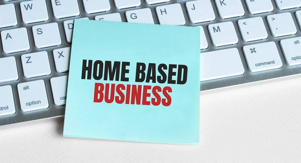 HOME BASED BUSINESS word concept on sticker on the keyboard