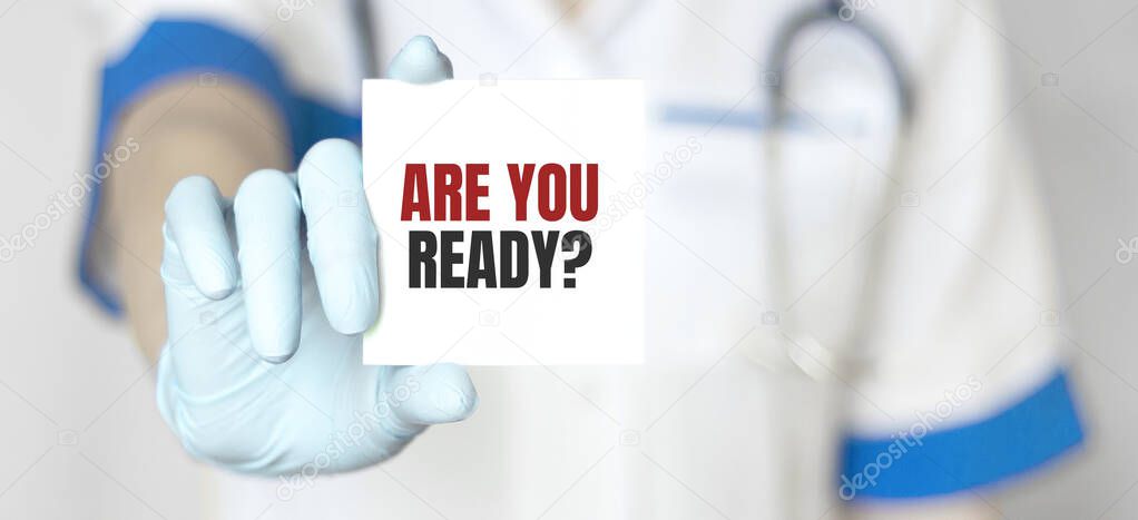 Doctor holding a card with text Are you ready, medical concept