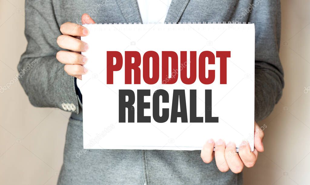 Businessman holding a card with text Product Recall