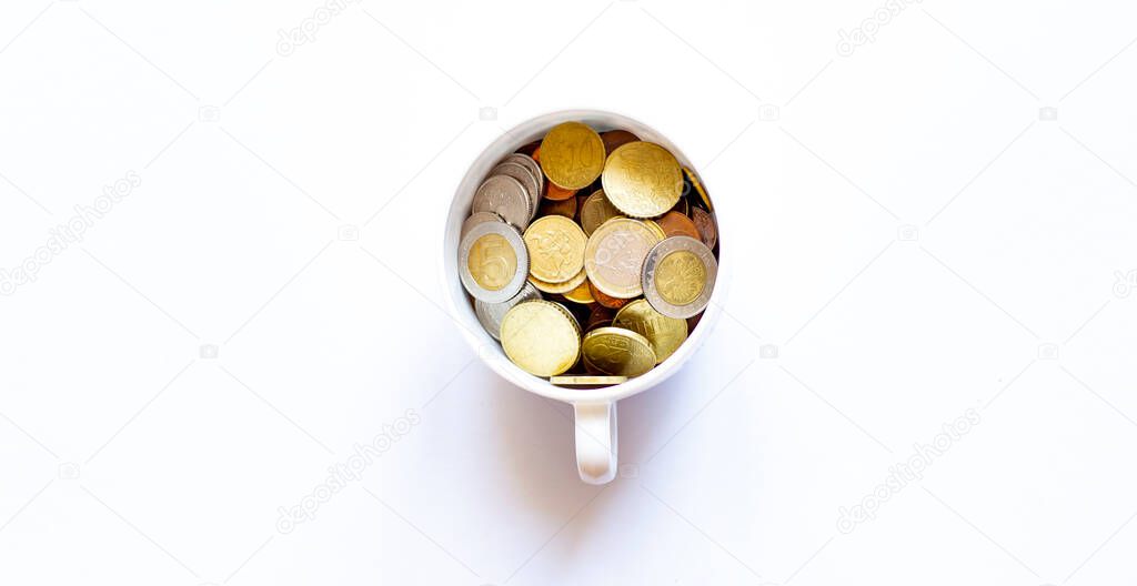 Cup of coins on the white background, business concept
