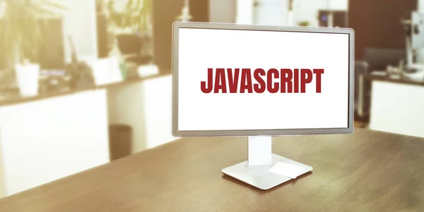 屏幕上有Javascript文本的现代办公室监视器 — 图库照片