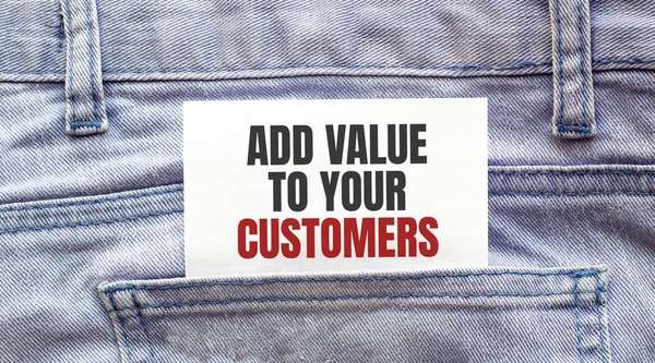 ADD VALUE TO YOUR CUSTOMERS words on a white paper stuck out from jeans pocket. Business concept