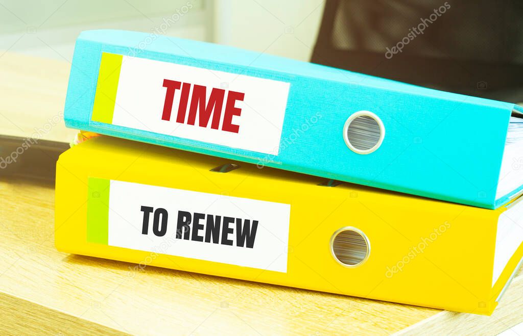 Two office folders with text TIME TO RENEW