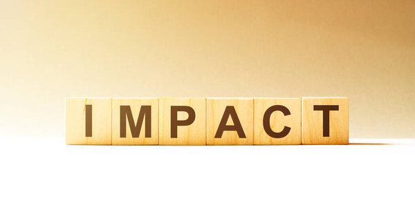 Word IMPACT made with wood building blocks