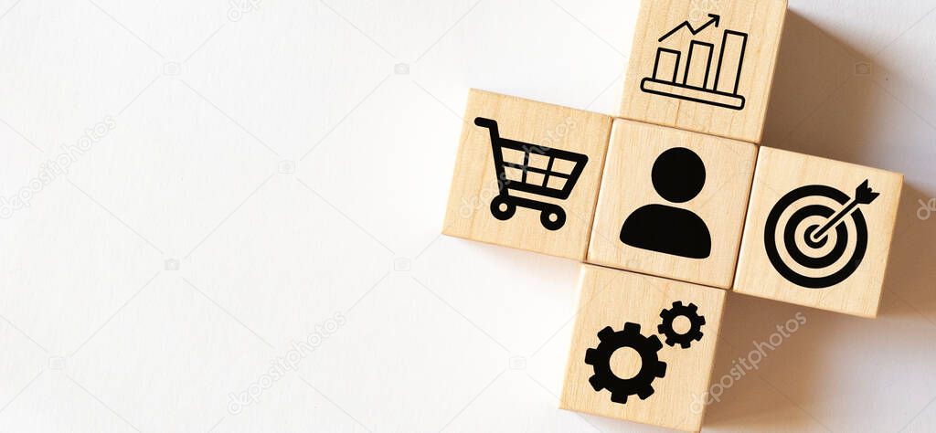 Sale volume increase make business success, Hand holding wood cube with icon goal and shopping cart symbol.