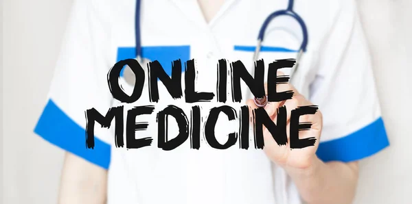 Doctor writting text ONLINE MEDICINE with marker,medical concept