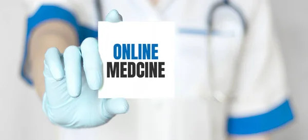 Doctor holding a card with text ONLINE MEDICINE,medical concept