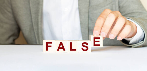 Word false made with wood building blocks