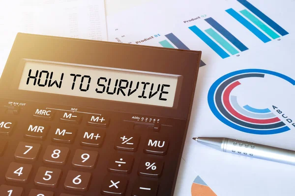 Word HOW TO SURVIVE on calculator. Business and finance concept.