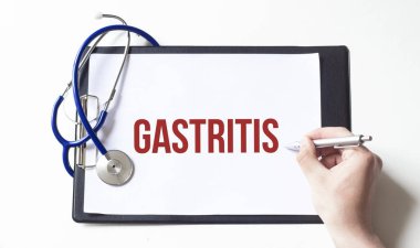 Doktor elinde GASTRITIS yazılı kağıt bir tabak tutuyor. Tıbbi konsept.