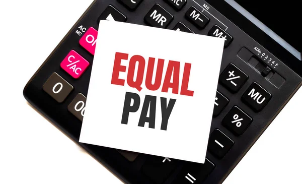 calculator with text EQUAL PAY with white paper