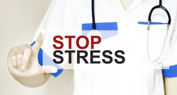 Doctor holding a card with text STOP STRESS, medical concept