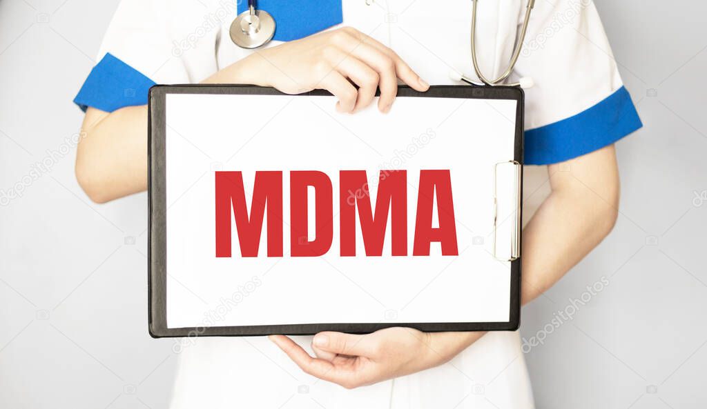 Doctor holding a paper plate with text MDMA, medical concept