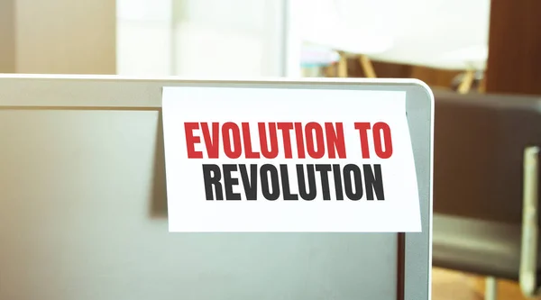 Sticky note on the computer. Text Evolution to Revolution