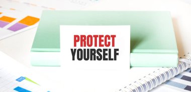 Beyaz büyük not defteri, yeşil kitap ve kâğıt sayfası üzerinde mali diyagram ve metin PROTECT kendin. İş konsepti