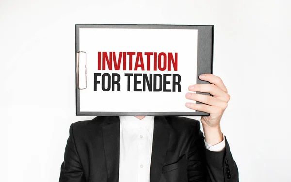 Show wait word on paper shown by business man isolated on white background. Text INVITATION FOR TENDER