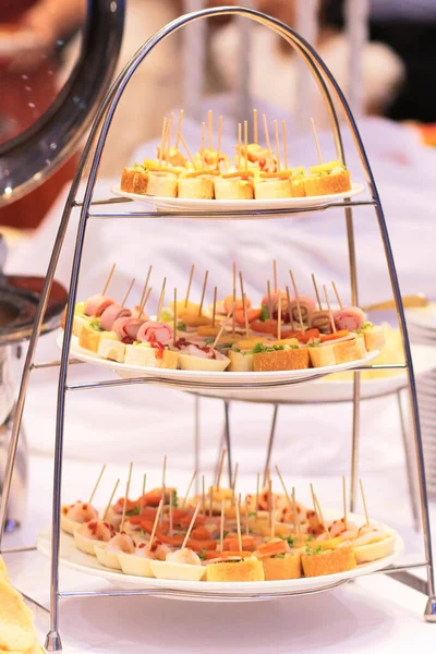 Delicious Buffet dessert set with cheese, meat, rolls, tortilla and fruit salad.  dessert table, cake, pie in weddig day