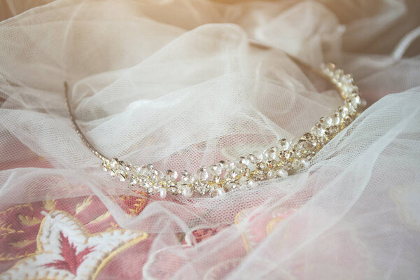 Beautiful crystal diadem on white vail of bride on vintage chair in wedding ceremony. Valentine day 