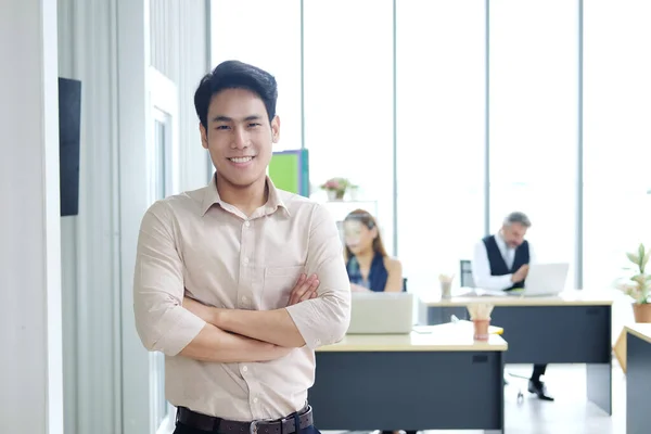 Smiling and Smart Asain businessman with teamwork at office. New nomal and social distace of business concept.