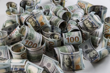 Yüzlerce dolarlık banknotlar beyaz arka planda toplanmış. Seçici odaklanma. Bulanık arkaplan.