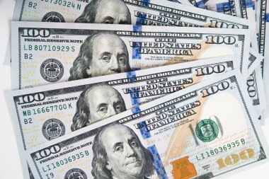 Beyaz arka planda 100 dolarlık banknotların yakın plan çekimi. Amerikan parası.