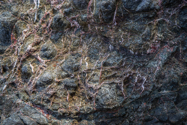 Colorful rock texture. Natural cracks void.