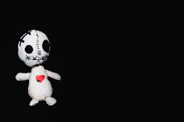 voodoo doll for your magic ritual on a black background clipart