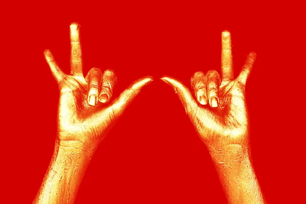 Golden hands on red background