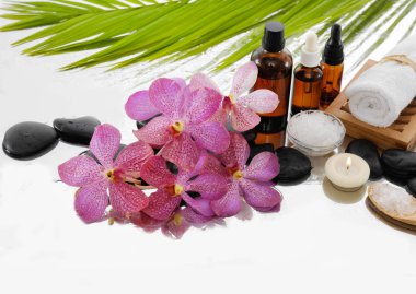 Spa konseptiyle palm, havlu, orkide, taşlar, petrol, kaşık tuz